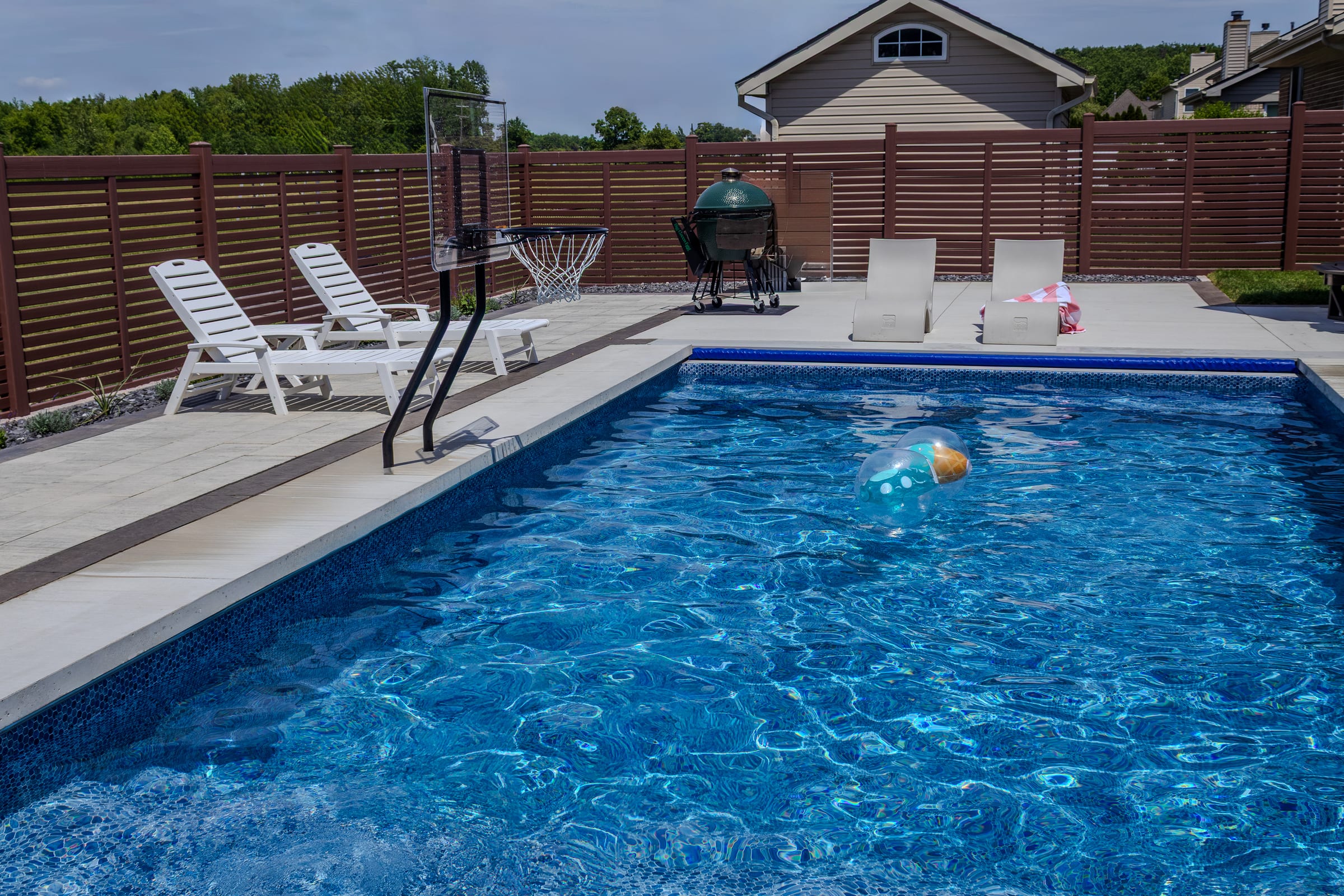 Finished pool deck and backyard landscaping by Gabriel's Pavers in Woodhaven, MI