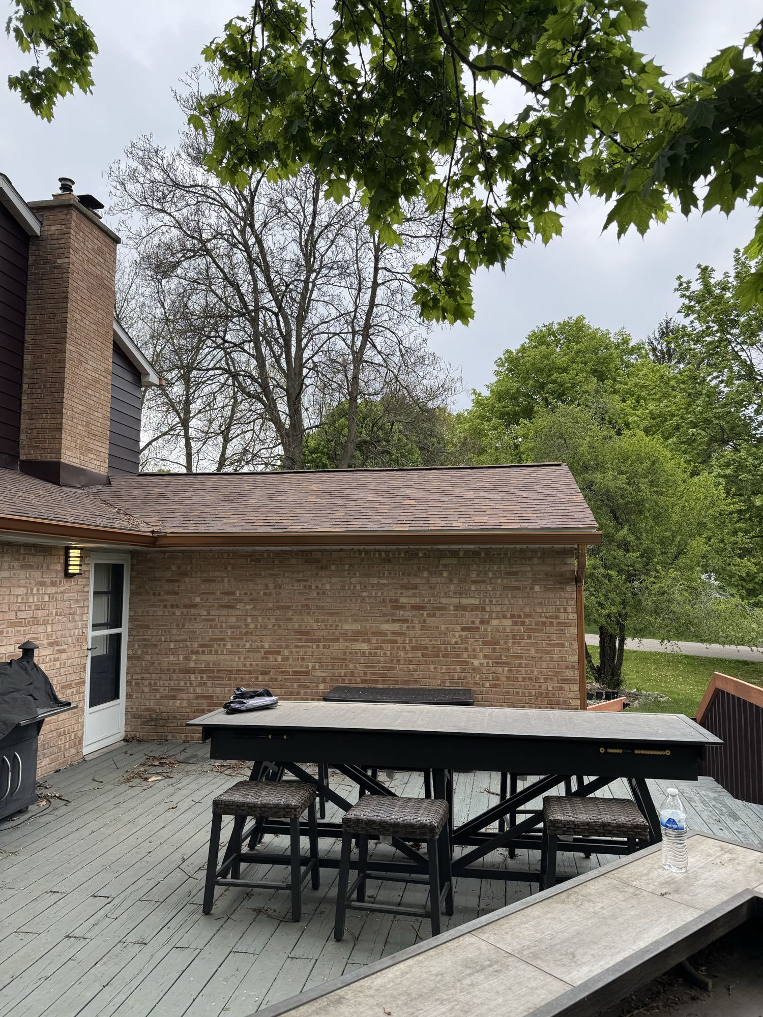 The same backyard before construction, showing the original grade and lawn