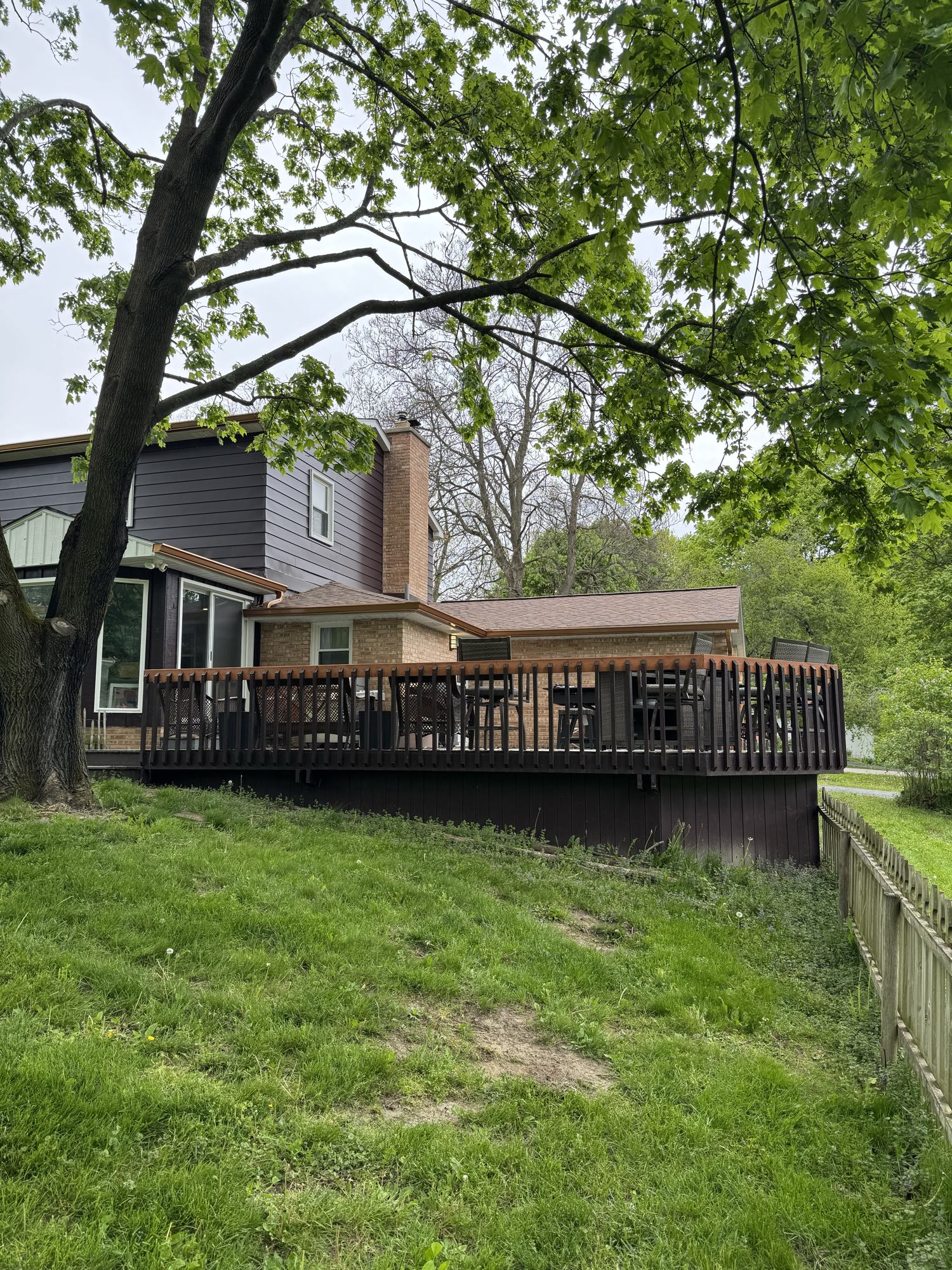 Before: the original railed wood deck and sloped backyard in Ypsilanti, MI